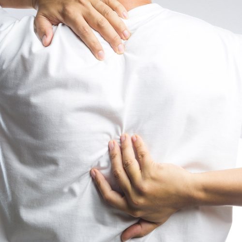 A man with back pain on white background